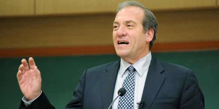 Rabbi Eckstein standing at a podium giving a speech.