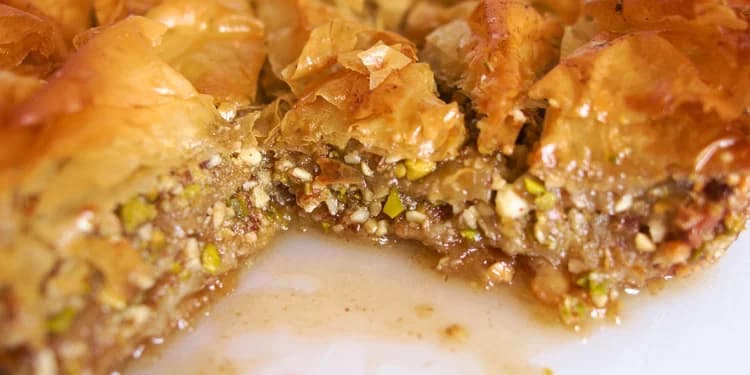 Delicious and flakey Baklava with a piece cut out of the side