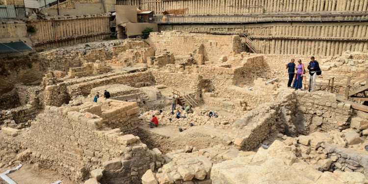 An architectural dig with several people inside it.