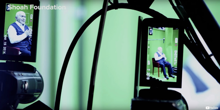 Man being recorded as he tells his Holocaust story.