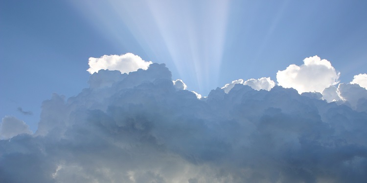 Cloudy sky with light shining through.