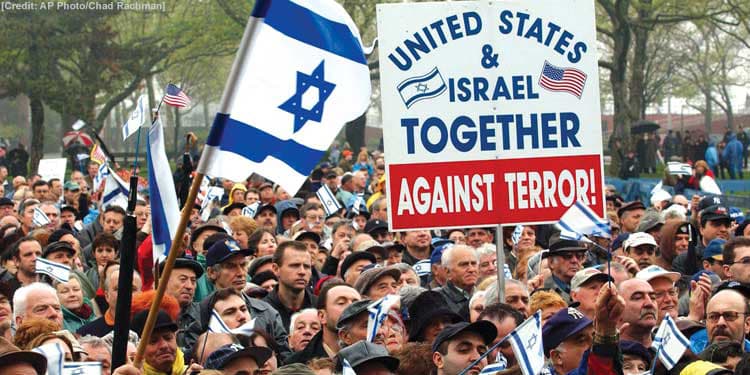 Crowd holding signs for the United States and Israel standing together.