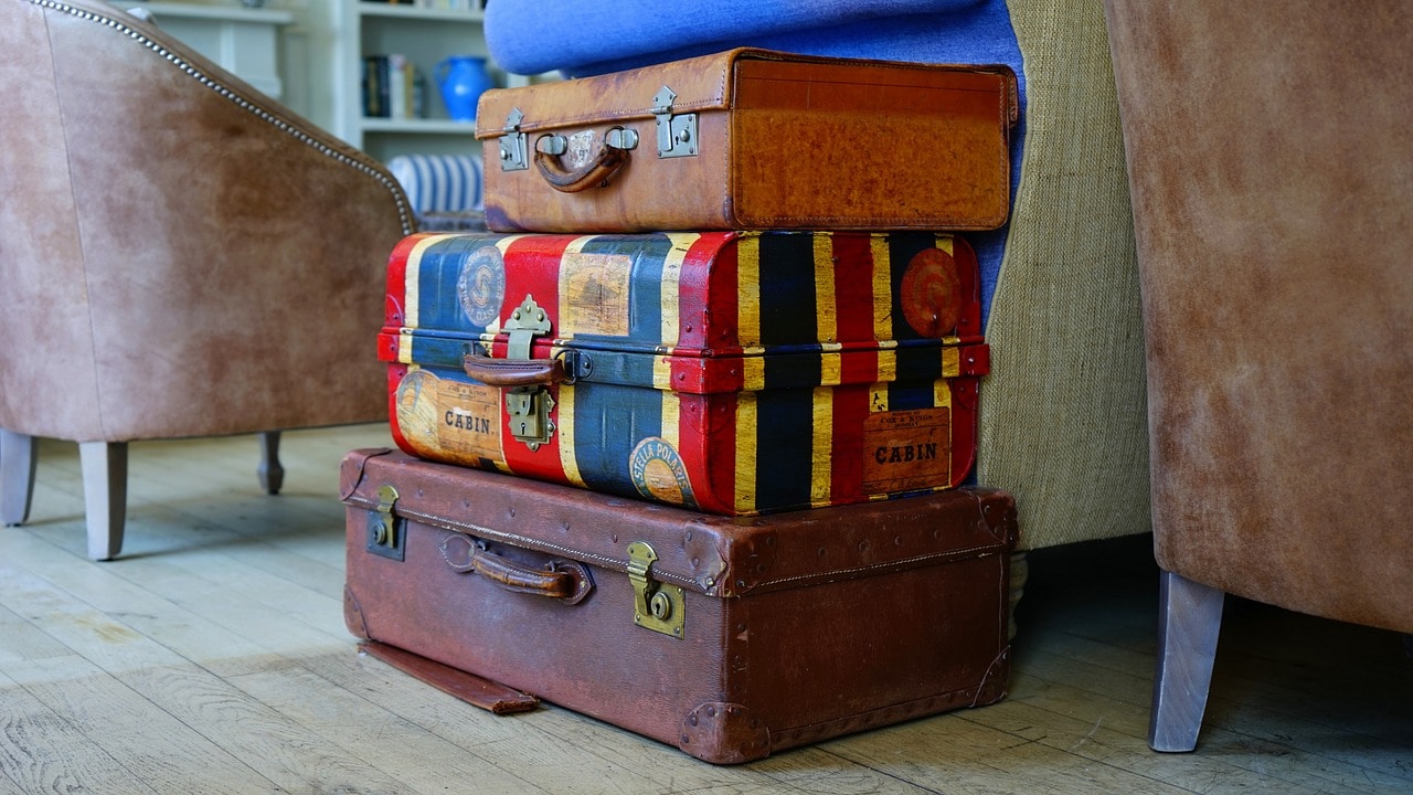 Several old luggage cases stacked on top of each other.