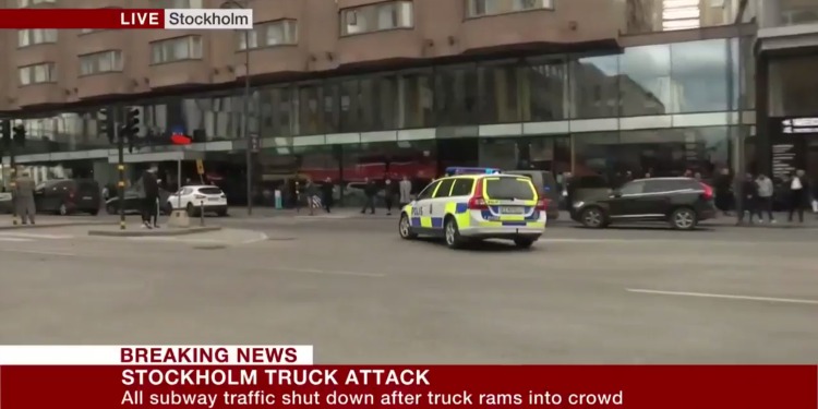 Screenshot of BBC News of an ambulance driving after a truck rams into a crowd.