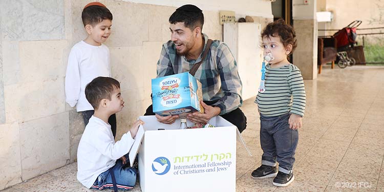 Family with young boys around food box