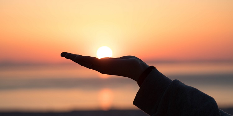 A hand appearing to hold the sunset in the background 2 Chronicles 15:2