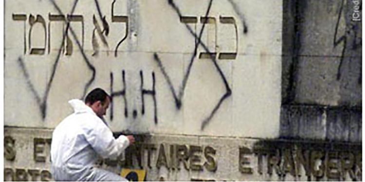 Anti Semitic graffiti being cleaned from a wall in France