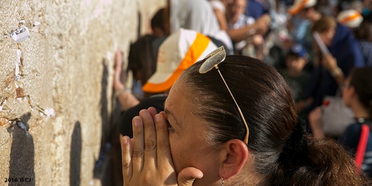Woman crying at Western Wall.