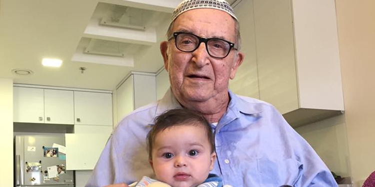 Elderly man posing with his grandchild